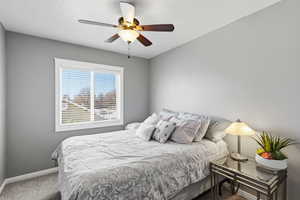 Bedroom with carpet floors and a ceiling fan