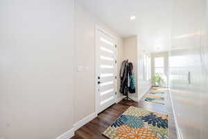 Entryway featuring dark wood-style flooring and recessed lighting