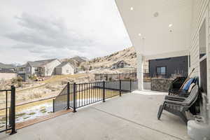 View of patio with a residential view and a mountain view