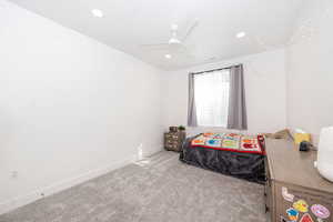 Bedroom featuring light carpet, a ceiling fan, and recessed lighting