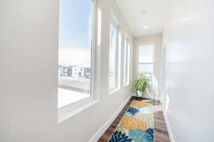 Corridor featuring dark wood finished floors and recessed lighting
