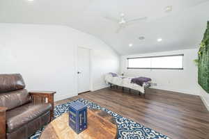 Bedroom featuring dark wood finished floors, recessed lighting, lofted ceiling, and ceiling fan