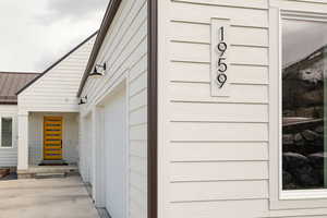 View of exterior entry with a metal roof