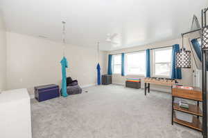 Playroom with light carpet and a ceiling fan