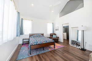 Bedroom featuring dark wood-type flooring, vaulted ceiling, recessed lighting, and a ceiling fan