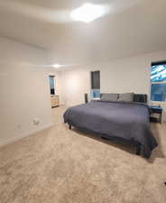 Bedroom featuring light colored carpet and baseboards