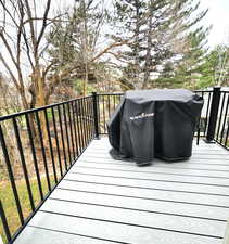 Wooden deck featuring a grill