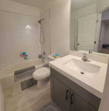 Full bathroom with vanity, tub / shower combination, and light tile patterned flooring