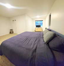 Carpeted bedroom featuring baseboards