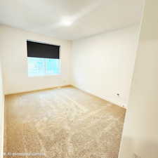 Empty room with light carpet and baseboards
