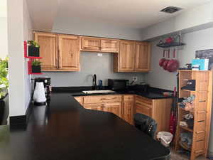 Kitchen featuring dark countertops and black microwave