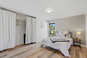 Bedroom featuring light wood-style flooring and a closet