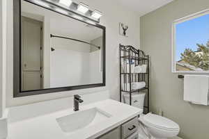 Bathroom featuring vanity and a shower