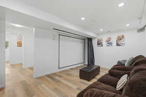 Home theater featuring light wood-style flooring and recessed lighting