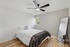 Bedroom with light wood finished floors and a ceiling fan
