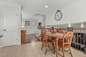Dining area with light tile patterned floors and recessed lighting