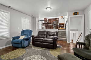 Living area featuring hardwood / wood-style flooring and a textured ceiling