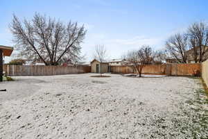Fenced backyard with an outbuilding