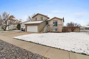 View of front of house featuring brick siding and driveway