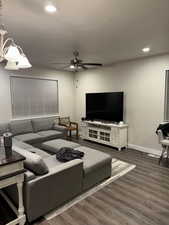 Living area featuring dark wood-style flooring, recessed lighting, and a ceiling fan