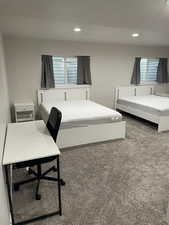 Carpeted bedroom with recessed lighting