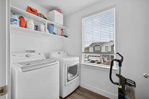 Laundry room featuring dark wood-style floors and washer and dryer