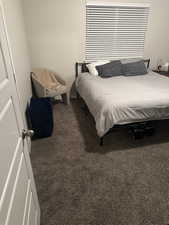 Carpeted bedroom featuring baseboards