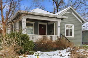 Shotgun-style home featuring covered porch