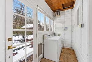 Laundry area featuring wooden ceiling, wooden walls, and washer hookup