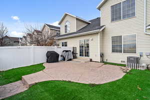 Back of house featuring a patio and a shingled roof
