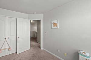 Unfurnished bedroom with light carpet, a closet, and a textured ceiling