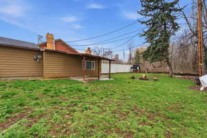 Fenced backyard featuring a patio and a fire pit