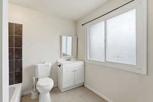 Full bathroom with vanity and light tile patterned flooring