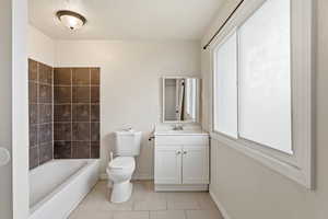 Bathroom featuring vanity, light tile patterned floors, and a textured ceiling