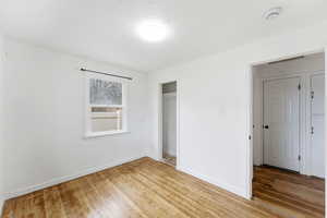 Unfurnished bedroom featuring light wood-type flooring and a closet