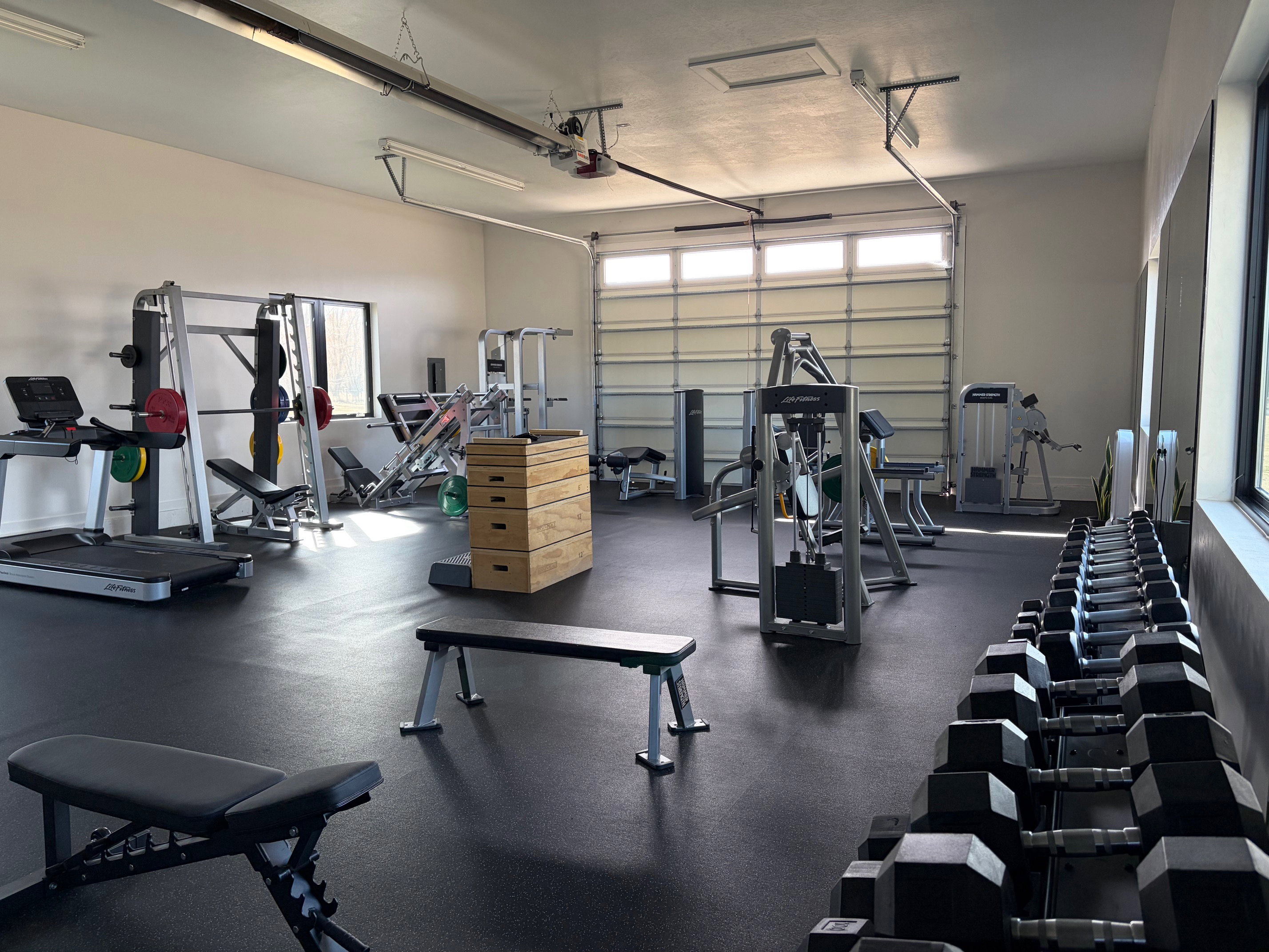 Exercise room featuring a garage