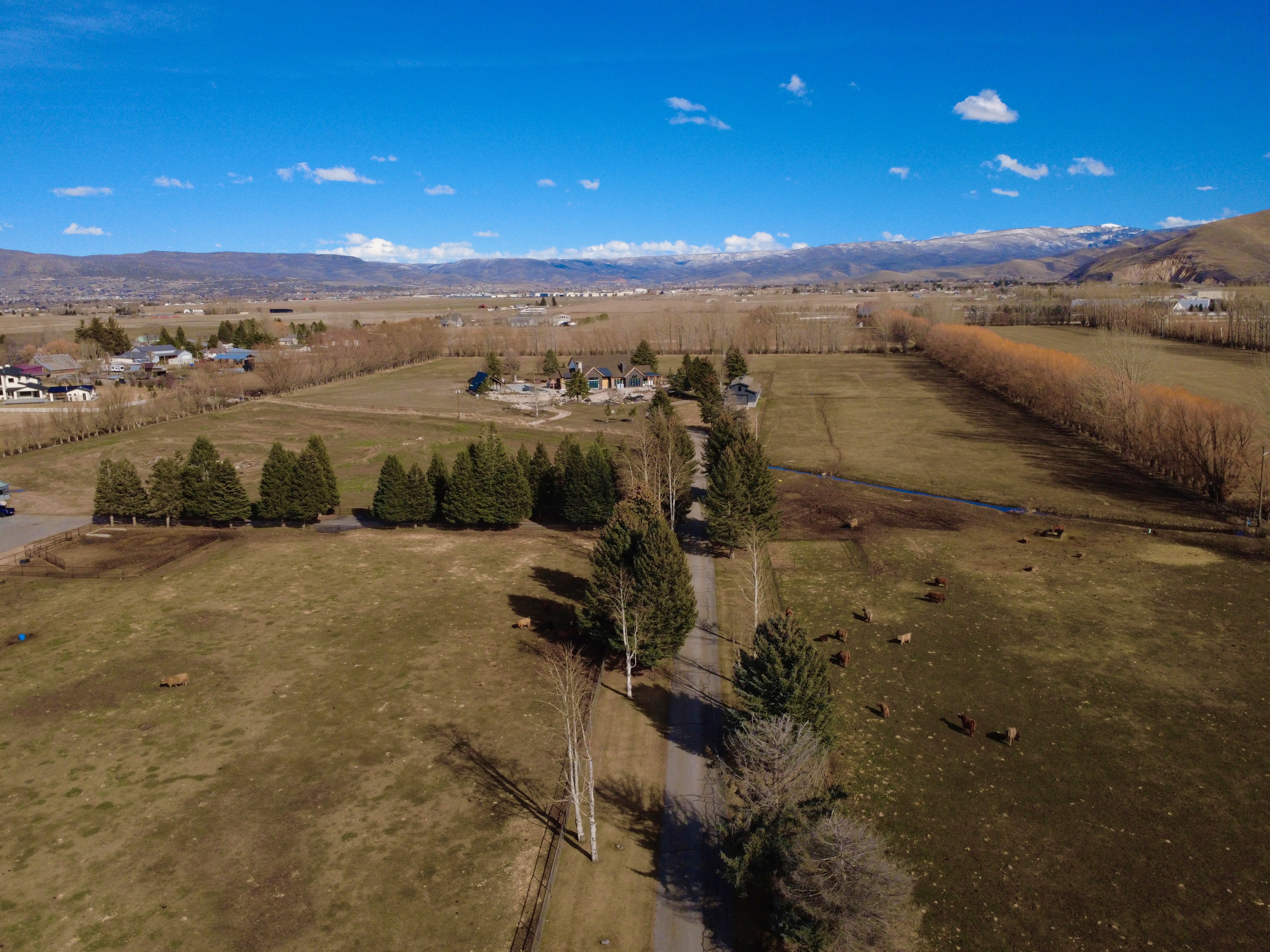 Aerial view of sparsely populated area with mountains and extensive farmland