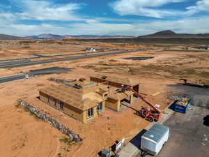 Aerial view of property and surrounding area featuring a mountain backdrop and rural landscape