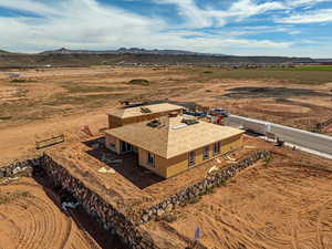 Aerial view of sparsely populated area featuring a desert landscape and a mountainous background