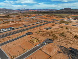Aerial overview of property's location featuring a mountainous background and rural landscape