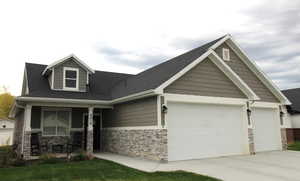 Craftsman-style house featuring stone siding, an attached 2-car garage, a concrete driveway, and a covered porch