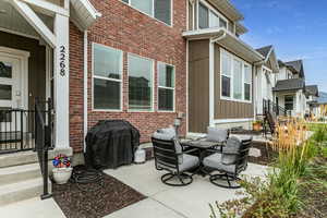 View of patio featuring grilling area and outdoor dining space