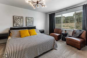 Carpeted bedroom with hanging lights and a textured ceiling