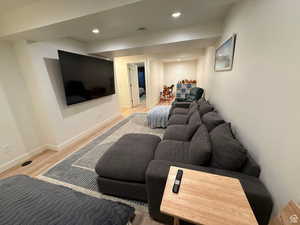 Living room featuring light wood finished floors and recessed lighting