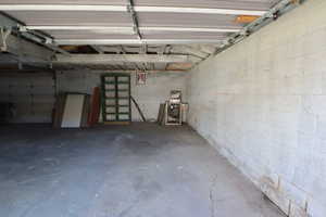 Garage featuring concrete block wall