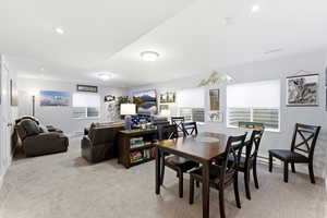 Dining area featuring light colored carpet and recessed lighting