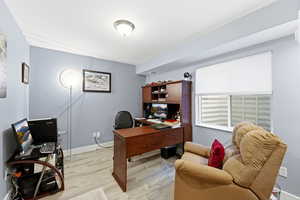 Office space with light wood finished floors and baseboards