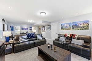 Living room with light colored carpet and recessed lighting
