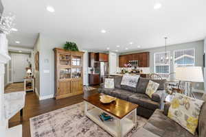 Living room with a chandelier and dark wood finished floors