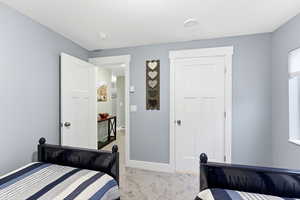 Bedroom with light carpet and baseboards